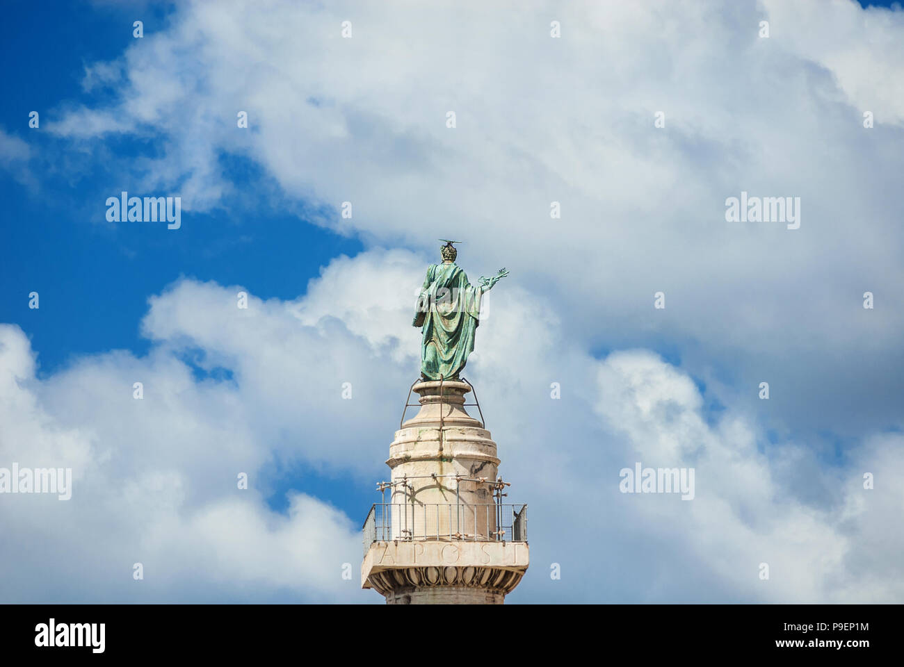 St Peter Apostle bronze statue with Bible and Keys of Heaven at the top of Trajan Column with clouds, in the historic center of Rome (16th century) Stock Photo