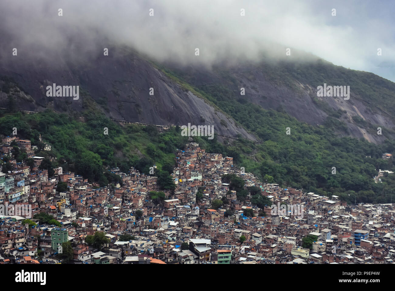 Favelas in Rio de Janeiro. Crowded area in the mountains of the city with a house over the other. No rules of architecture here. Stock Photo