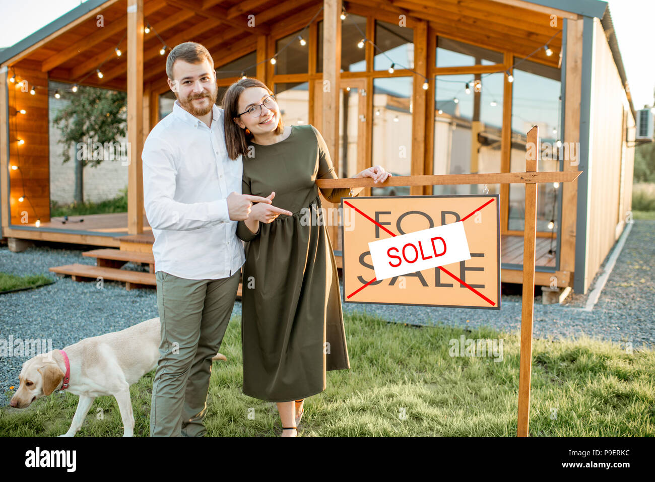 Couple in front of their new house Stock Photo - Alamy