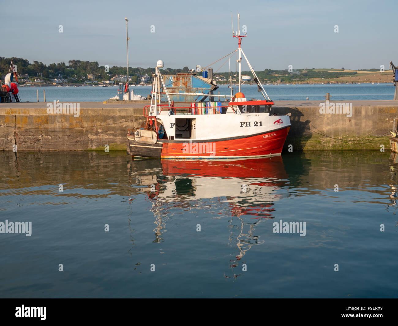 Commercial fishing boats moored in Padstow harbour Cornwall UK in evening sunlight Stock Photo