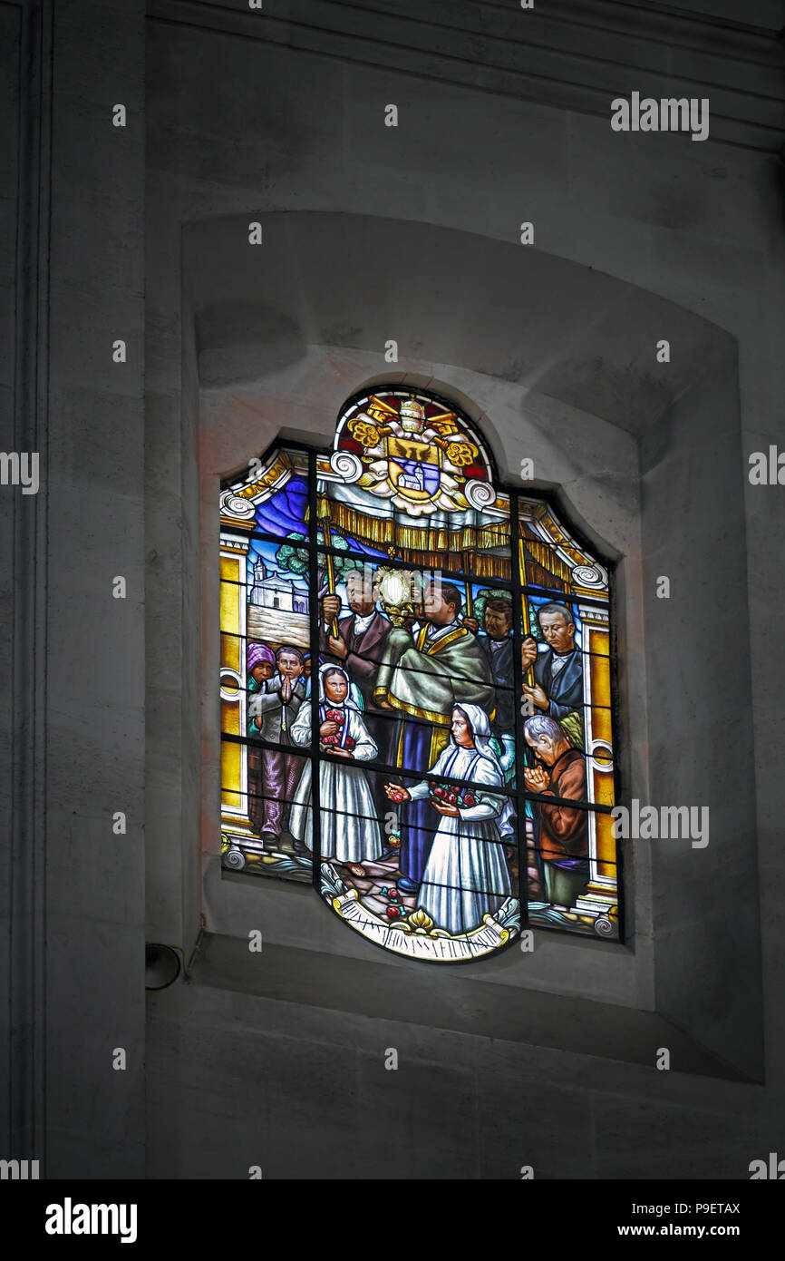 One of the stained glass windows of the basilica of Fatima representing an old procession Stock Photo