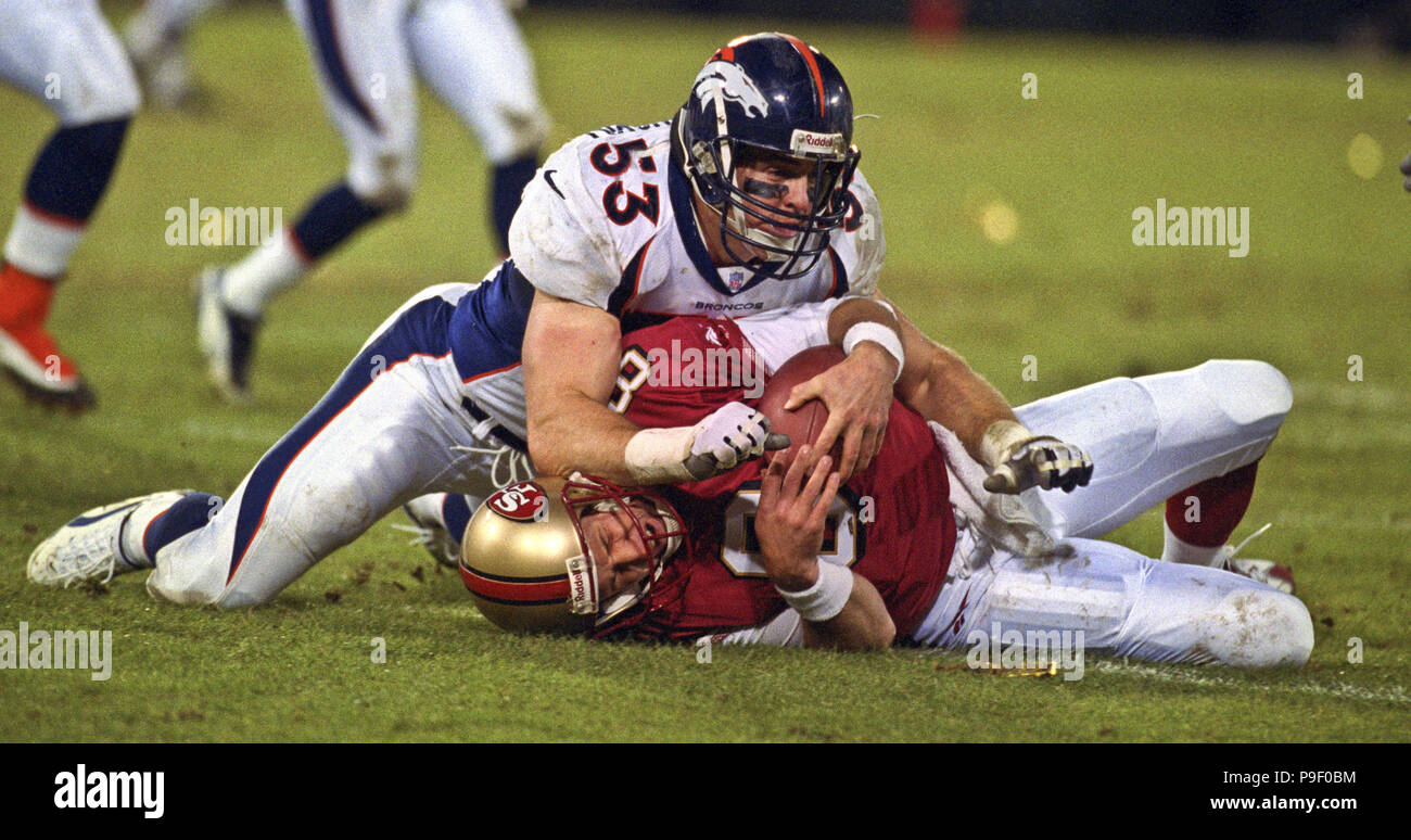 San Francisco, California, USA. 15th Dec, 1997. San Francisco 49ers vs. Denver Broncos at Candlestick Park Monday, December 15, 1997. 49ers beat Broncos 34-17. Denver Broncos linebacker Bill Romanowski (53) hits San Francisco 49ers quarterback Steve Young (8) on the ground. Credit: Al Golub/ZUMA Wire/Alamy Live News Stock Photo