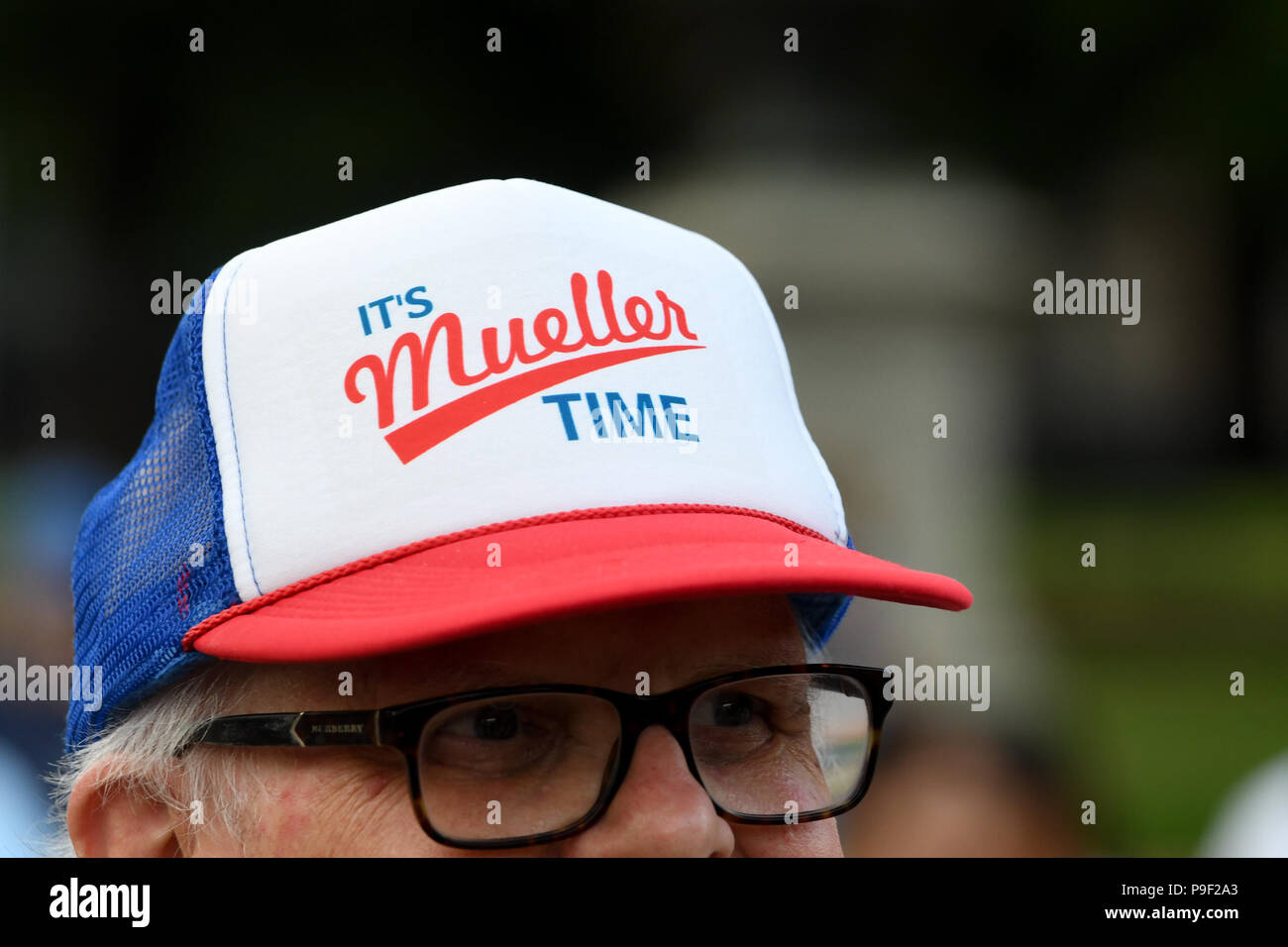 Washington DC, USA. 17th July 2018. A protester proudly wears a ''It's Mueller Time'' hat during a protest organized by Michael Avenatti in front of the White House, just two days after Donald Trump's gaffs in Helsinki, Finland with Vladimir Putin. Credit: Cal Sport Media/Alamy Live News Stock Photo