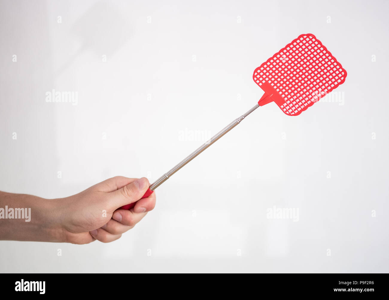 Germany, Berlin. 16th July, 2018. A person is holding a fly swatter in his hand. Often a hearty slash helps. By registering the plastic swatter at the German Patent Office 65 years ago, the chances of survival of flies, mosquitoes and Co. have shrunk rapidly. Credit: Fabian Sommer/dpa/Alamy Live News Stock Photo