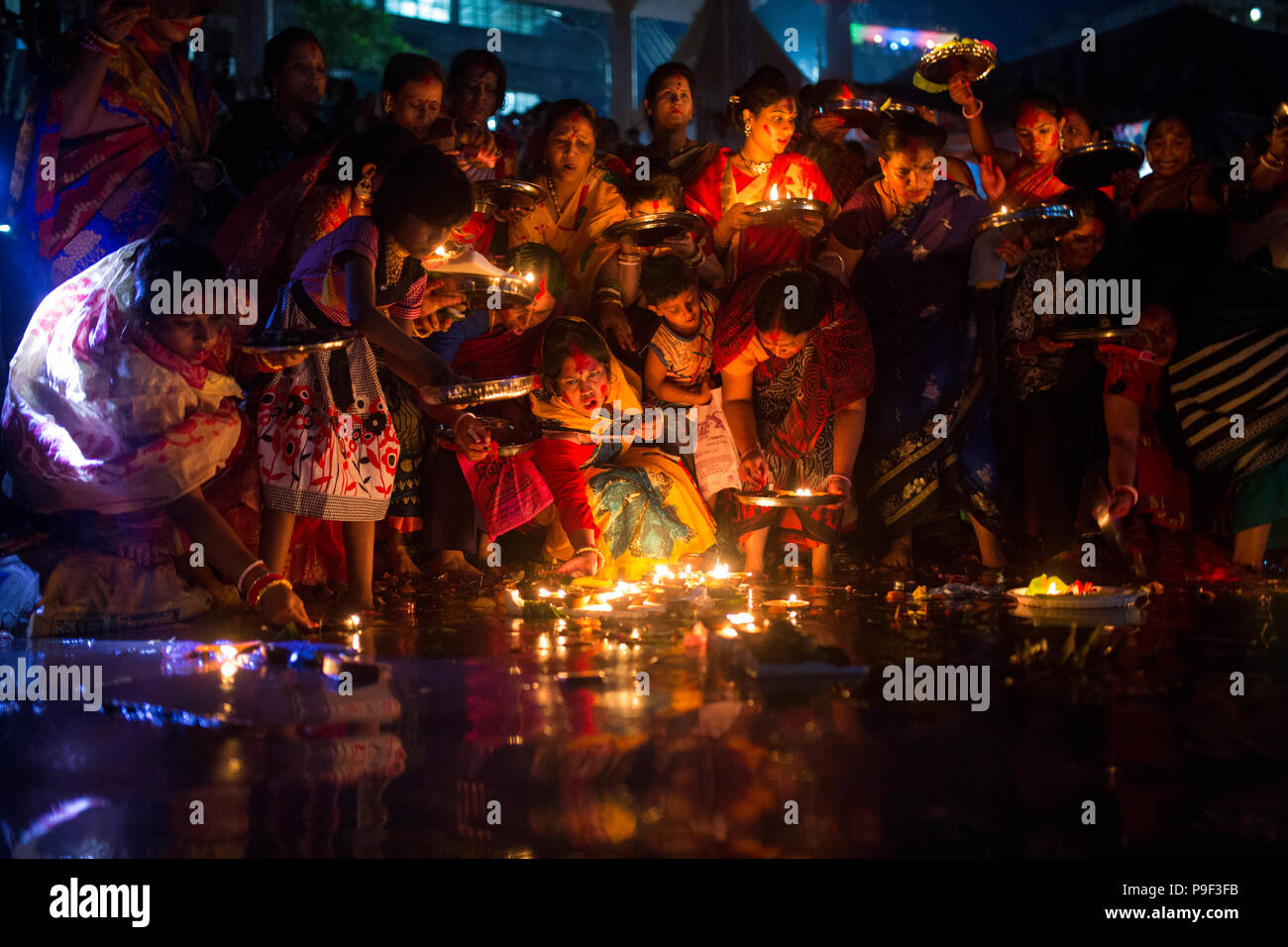 Dhaka, Bangladesh. 17th July, 2018.  Hindu devotees offer prayer hold lamps as they attend a ritual named Bipodnashini Puja that Puja against evil and danger  in old Dhaka , Bangladesh. Credit: zakir hossain chowdhury zakir/Alamy Live News Stock Photo