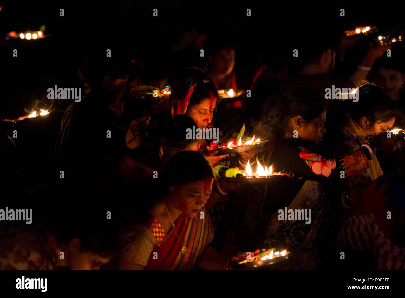 Dhaka, Bangladesh. 17th July, 2018.  Hindu devotees offer prayer hold lamps as they attend a ritual named Bipodnashini Puja that Puja against evil and danger  in old Dhaka , Bangladesh. Credit: zakir hossain chowdhury zakir/Alamy Live News Stock Photo
