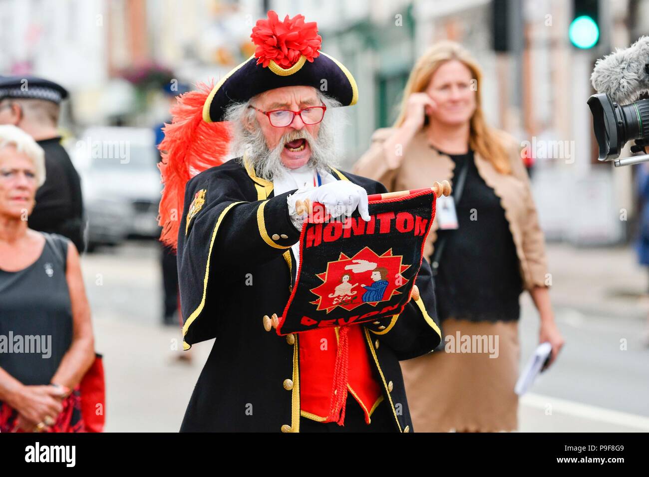 Honiton, Devon, UK.  18th July 2018.   The Duke and Duchess of Cornwall visit the Gate to Plate food market at Honiton in Devon.  Honiton town crier Dave Retter gives a rousing welcome cry.  Picture Credit: Graham Hunt/Alamy Live News Stock Photo