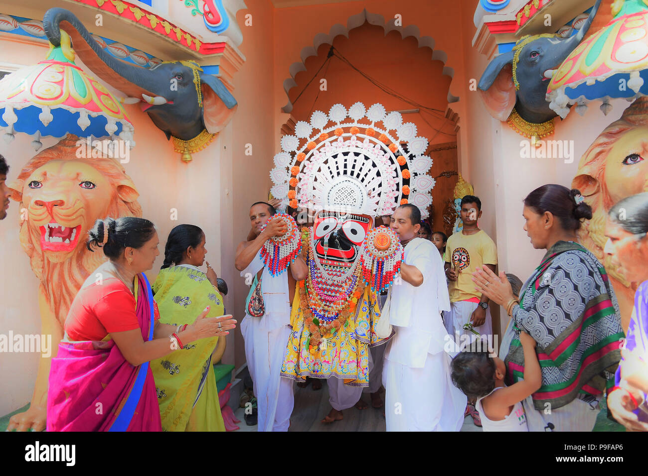 July 14, 2018 - Agartala, Tripura, India - Hindu priests seen carrying the idol during the celebration..Rath Yatra is an annual festival that involves devotees pulling a chariot of lord Jagannatha, his brother Balabhadra and sister Subhadra. (Credit Image: © Abhisek Saha/SOPA Images via ZUMA Wire) Stock Photo