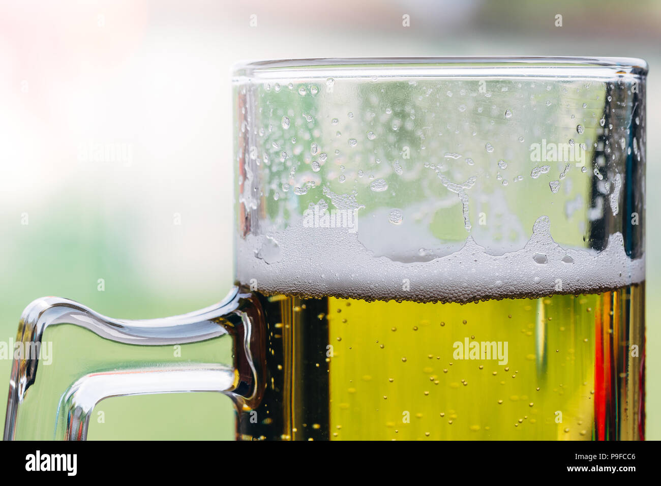 Close up of a glass of beer with foam on top. Stock Photo