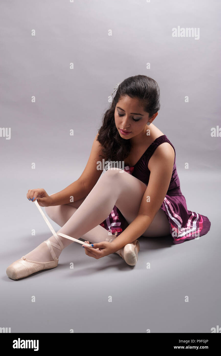 15 years old Mexican teenager girl (XV Años or Quinceañera in spanish) during her birthday photo session, wearing her ballet outfit and pointe shoes Stock Photo