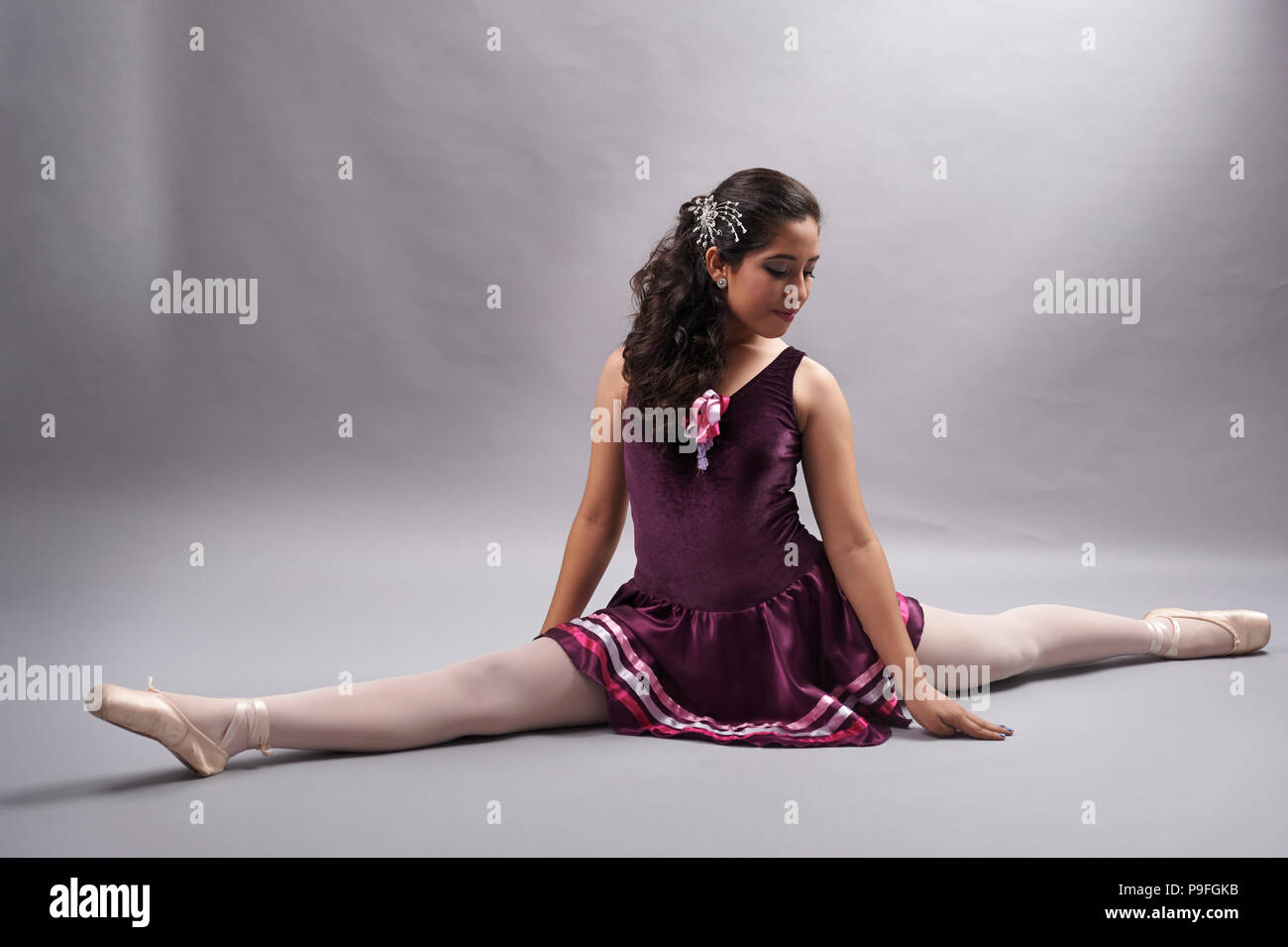 15 years old Mexican teenager girl (XV Años or Quinceañera in spanish) during her birthday photo session, wearing her ballet outfit and pointe shoes Stock Photo