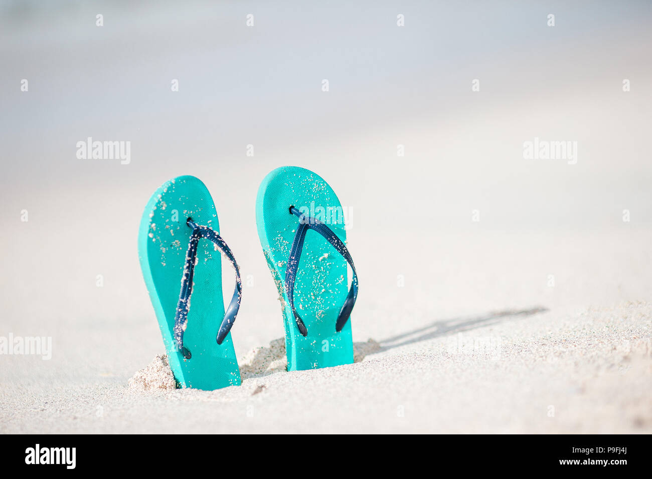 Summer mint flip flops with sunglasses on white beach Stock Photo - Alamy