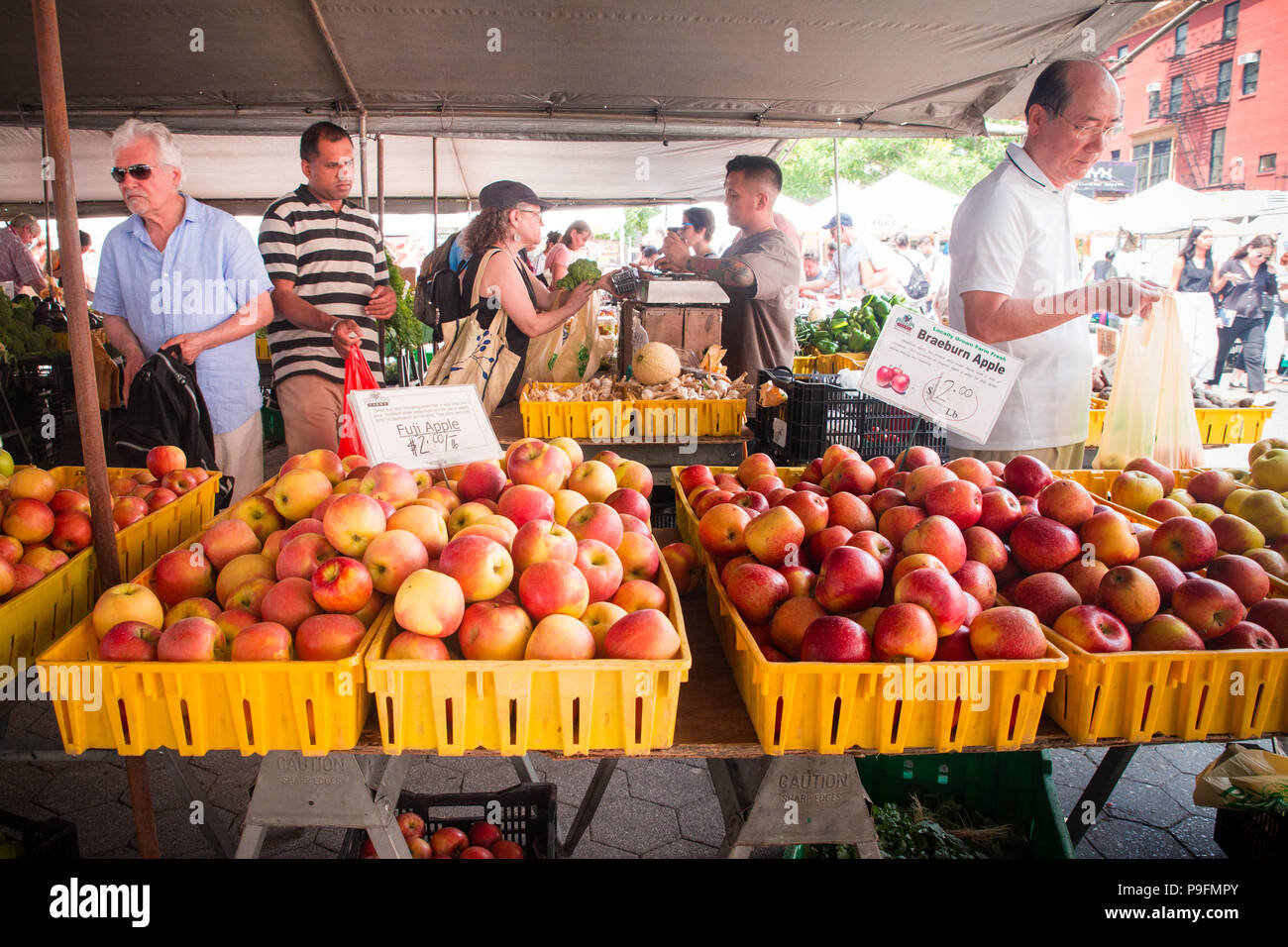 NEW YORK CITY JULY 16, 2018 Shoppers buying produce on display at