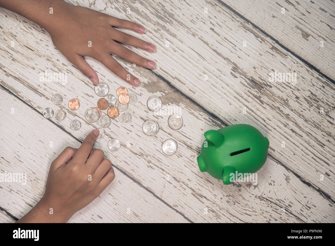 Young girls hands counting money from her piggy bank. Stock Photo