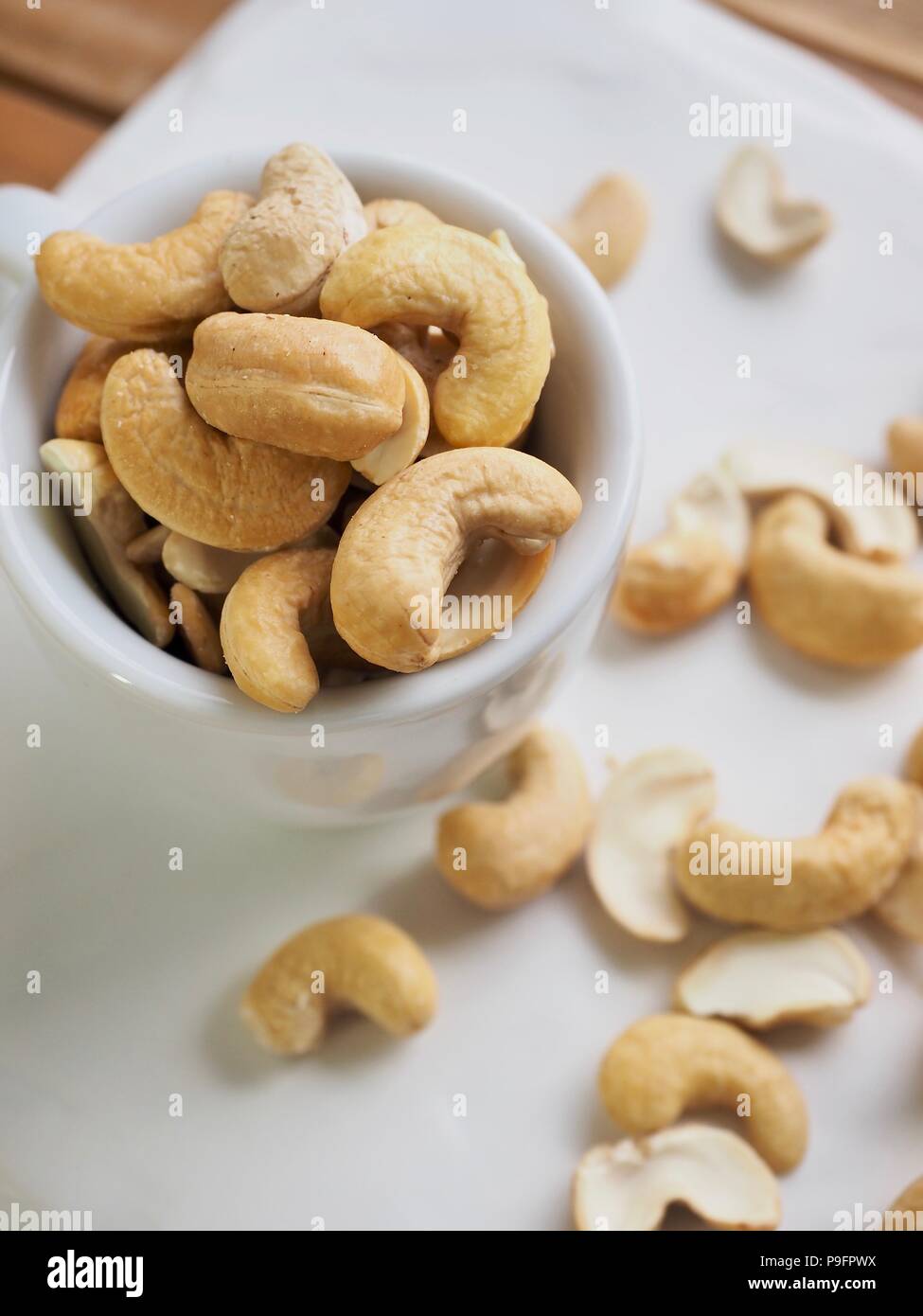Cashew nuts in a coffee cup Stock Photo