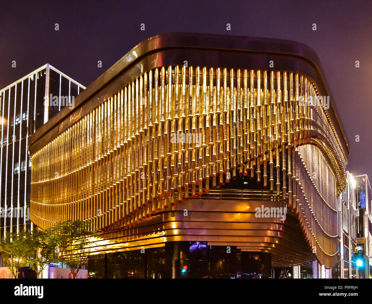 Shanghai, China - Apr. 24, 2018: Fosun Foundation cultural and arts center with moving curtain-like façade made of bronze tubes. Stock Photo