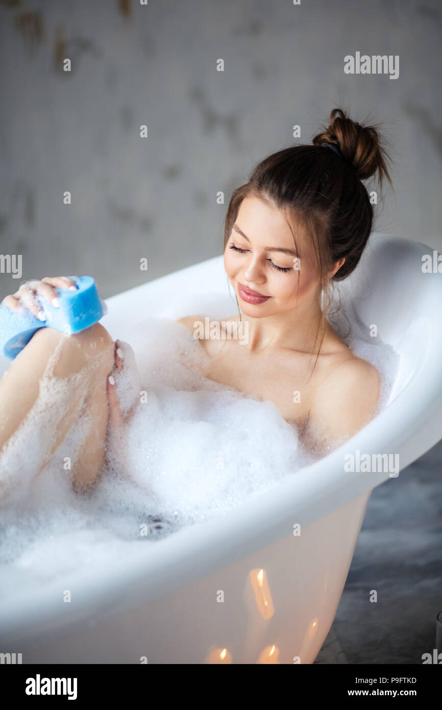 female washing her legs after shaving her legs. washing activity Stock Photo Alamy