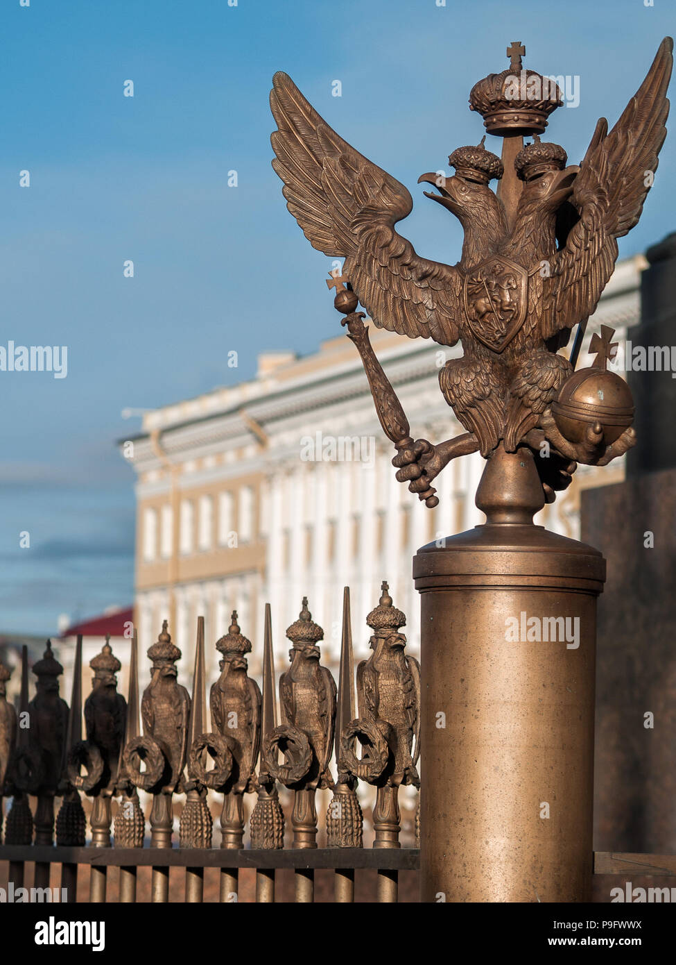 Figure of the three-headed eagle in the imperial crown on the fence of the pillar of Alexandria on Palace Square in the center of St. Petersburg, Russ Stock Photo