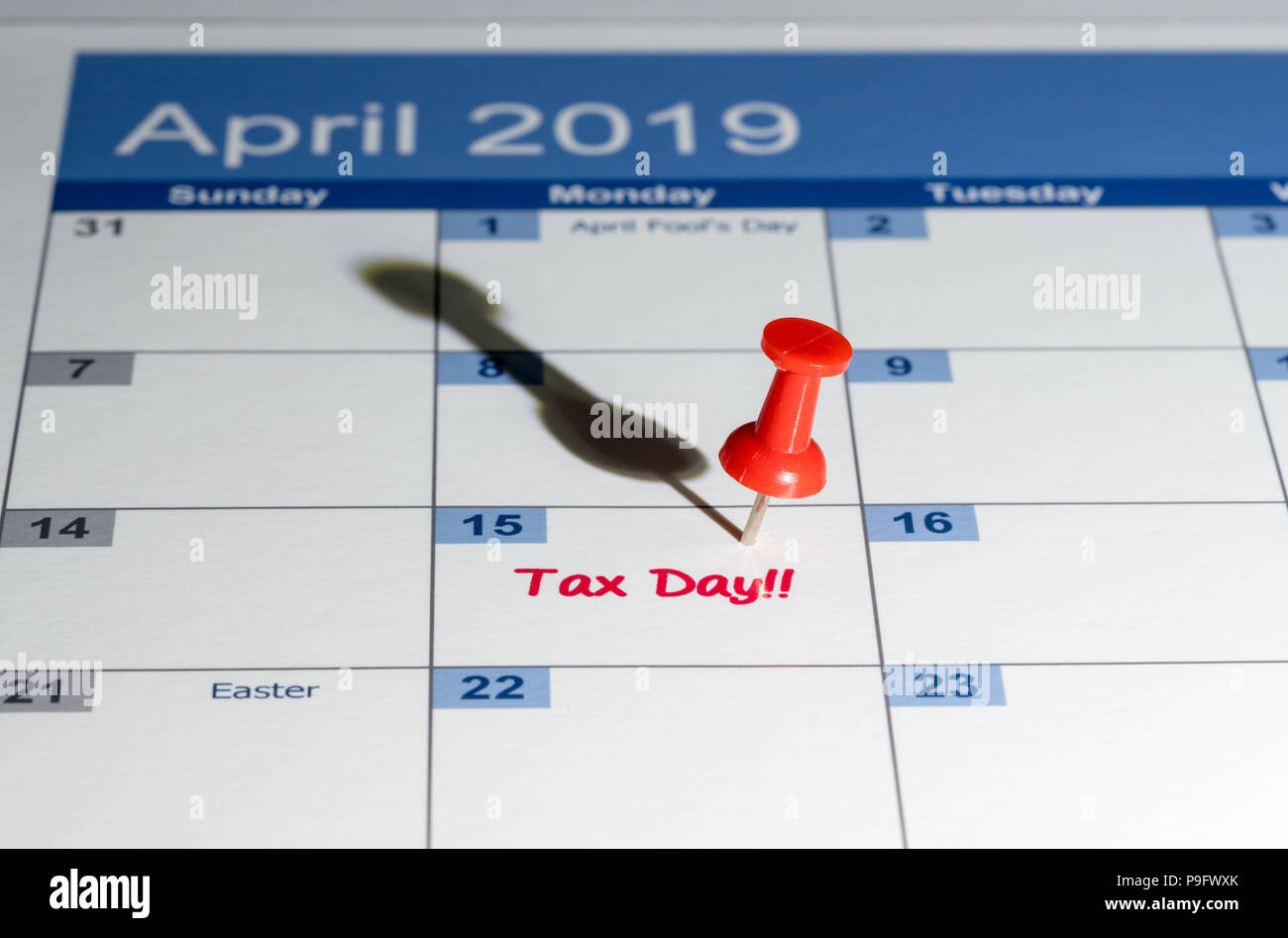 Red pushpin in calendar on April 15th for tax day Stock Photo