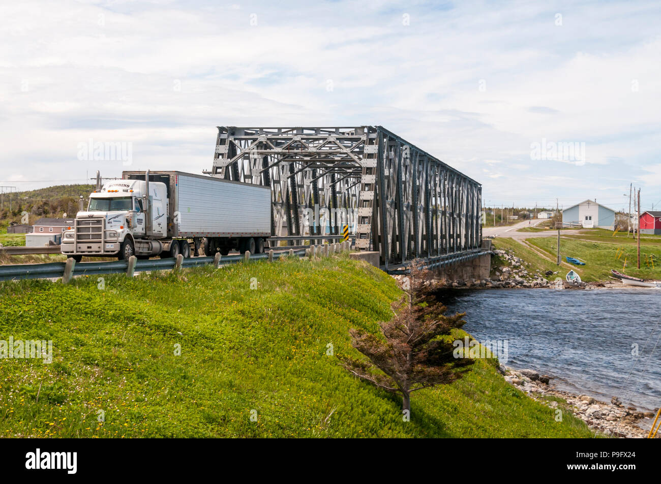 Large truck crossing the bridge at St. Paul's on Newfoundland Northern Peninsula.  Highway 430, the Viking Trail, is the main route up the peninsula. Stock Photo