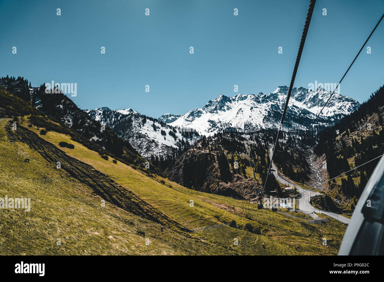 Almaty, Kazakhstan ski lift, cable car cabin at Medeo to Shymbulak route against mountain background Stock Photo