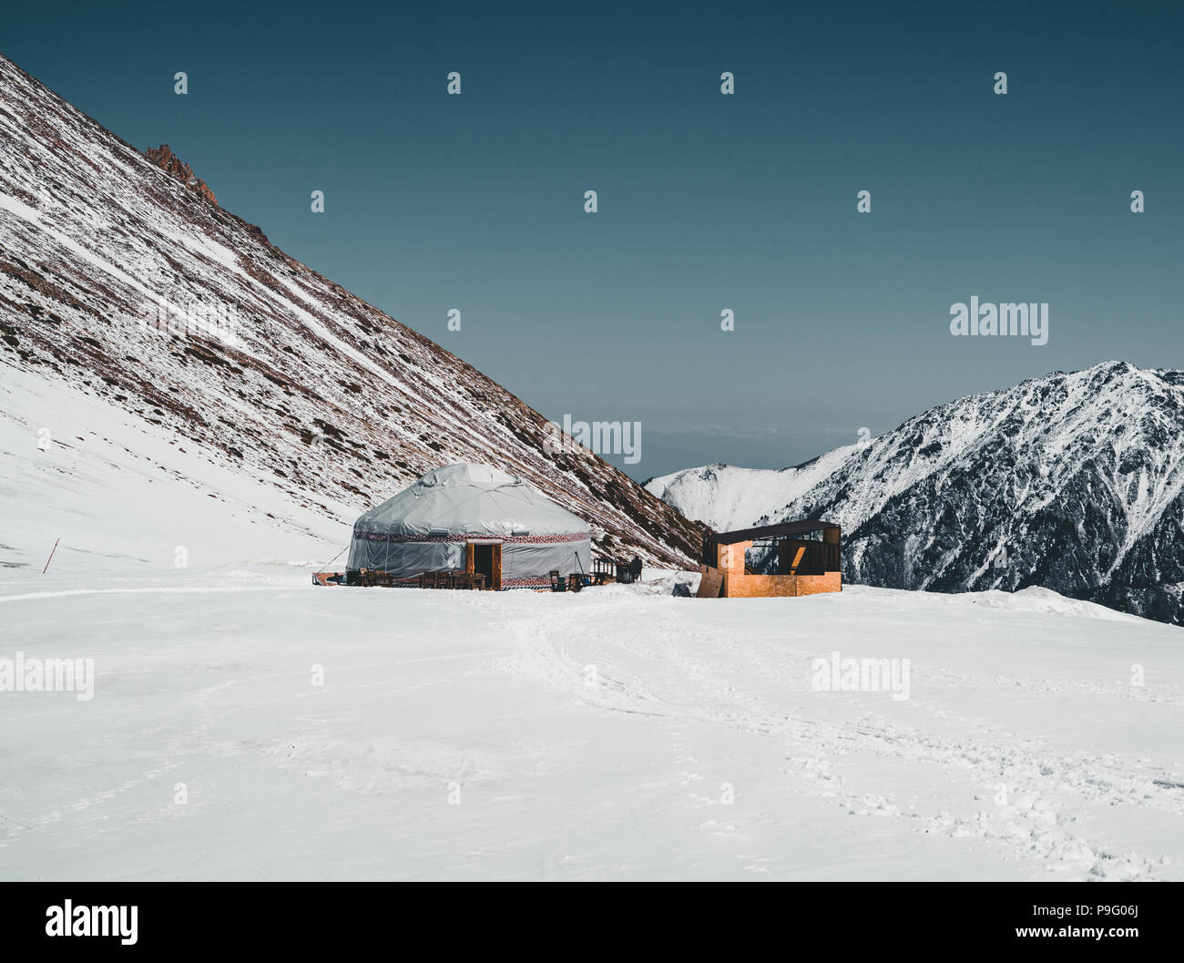 Shymbulak Ski Resort in Almaty mountains with traditional yurt. now-capped Tian Shan in Almaty city, Kazakhstan, Central Asia. Stock Photo