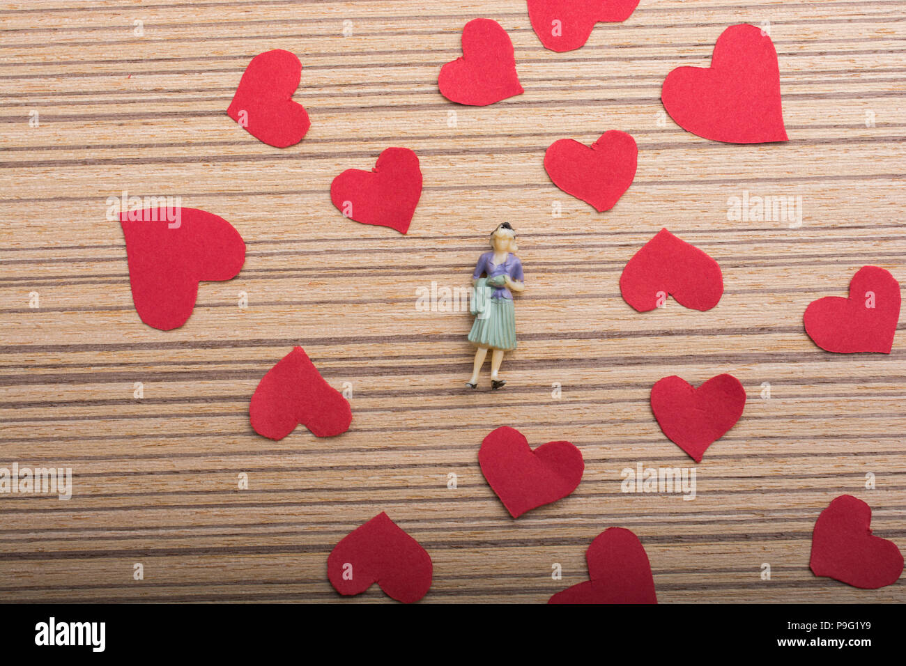 Woman figurine and Love concept with red paper hearts Stock Photo - Alamy