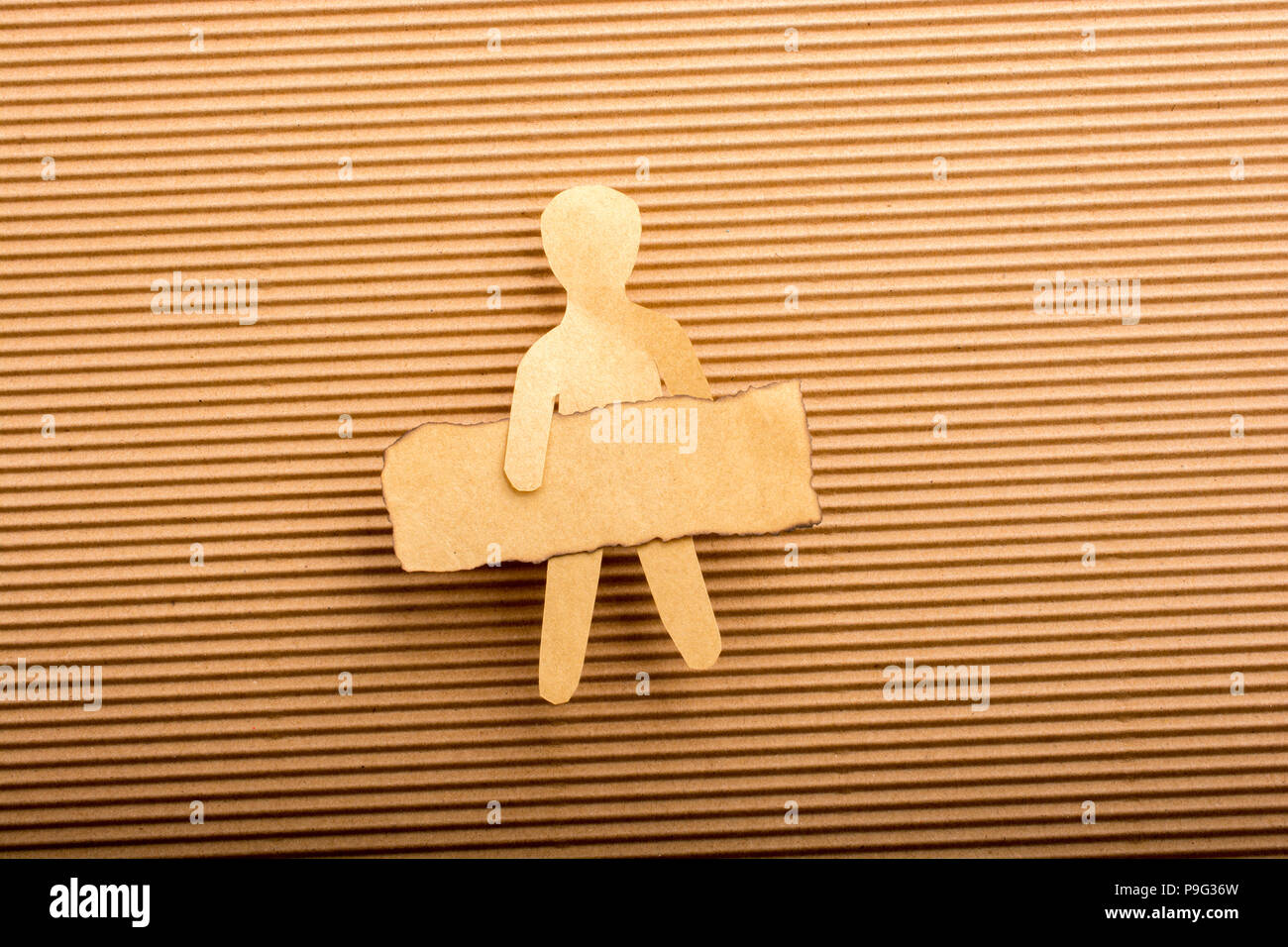 Paper man shape holding burnt note paper in hand Stock Photo