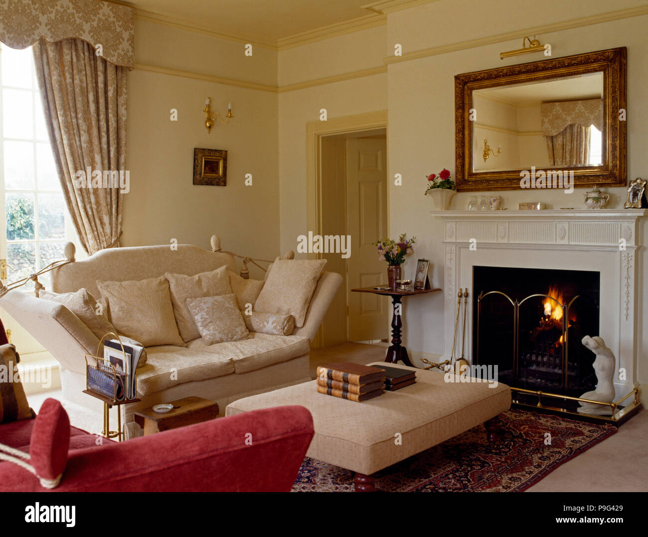 Mirror Above Fireplace With Lighted Fire In Cream Country Country