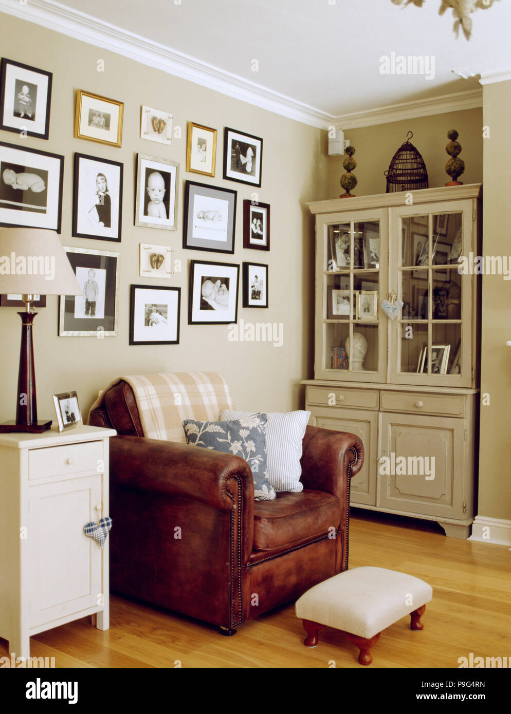 Framed Black White Photographs On Wall Above Brown Leather