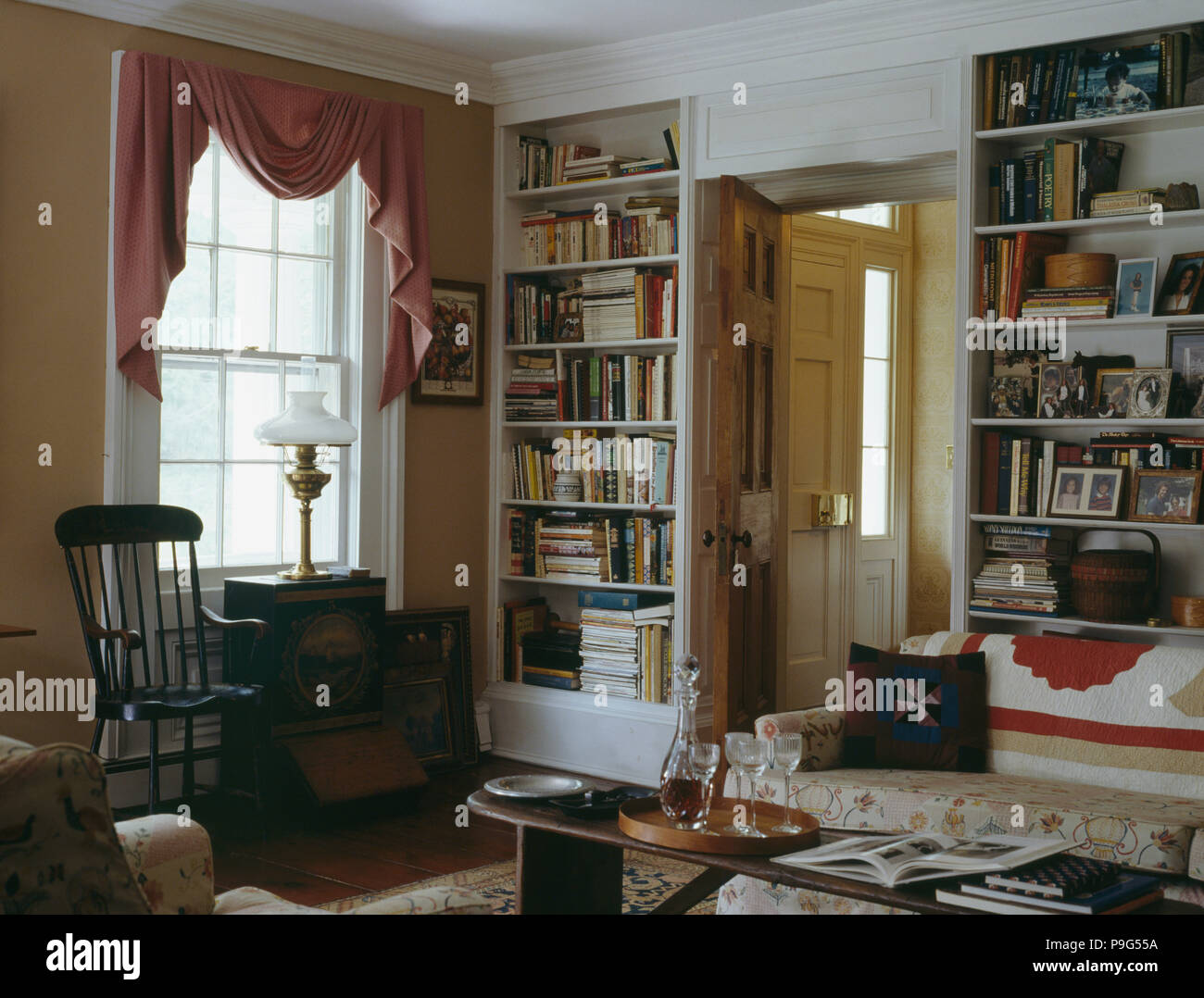 Fitted Bookcases On Either Side Of Doorway In Country Living Room