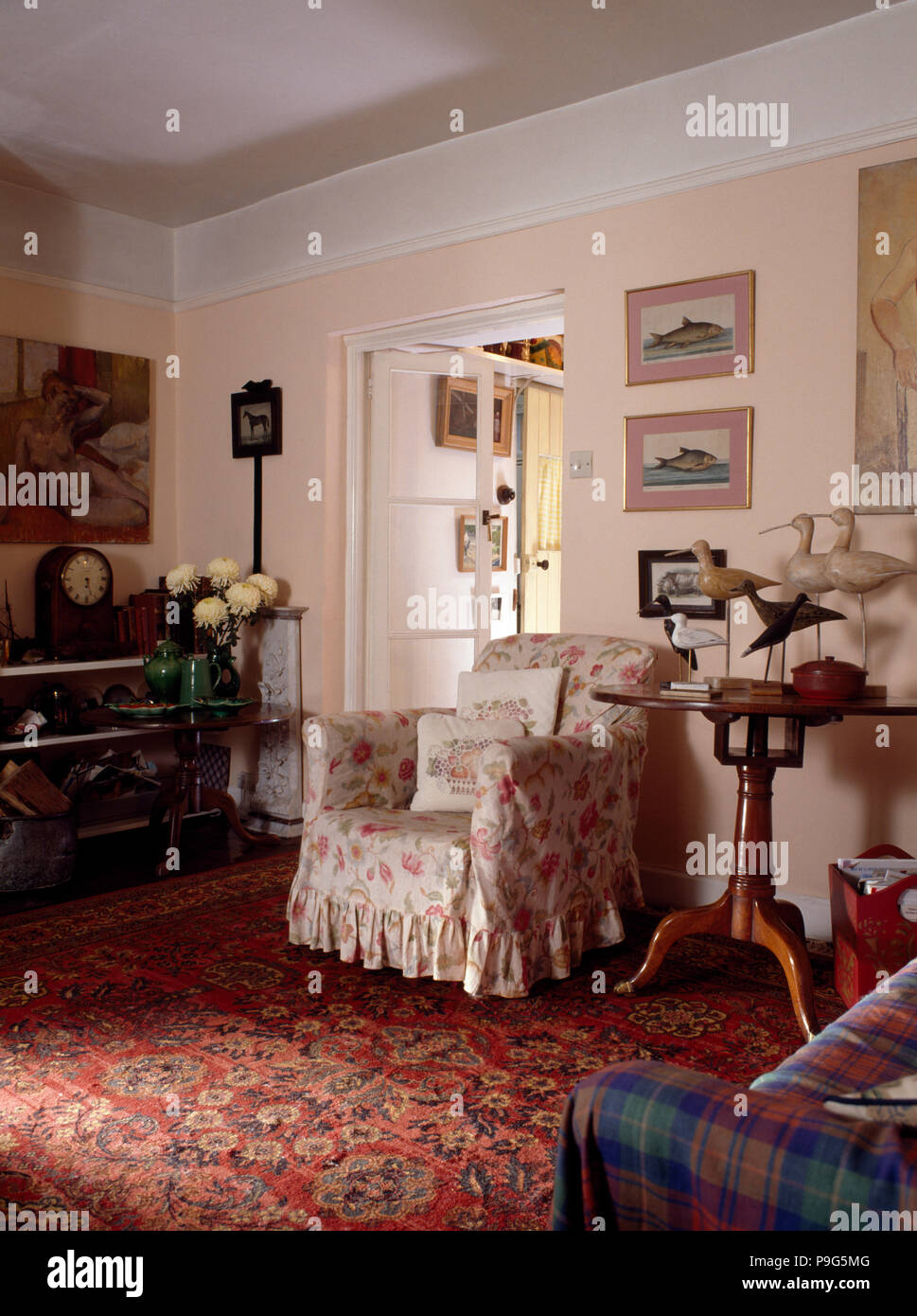 Floral armchair in eighties cottage kitchen Stock Photo Alamy