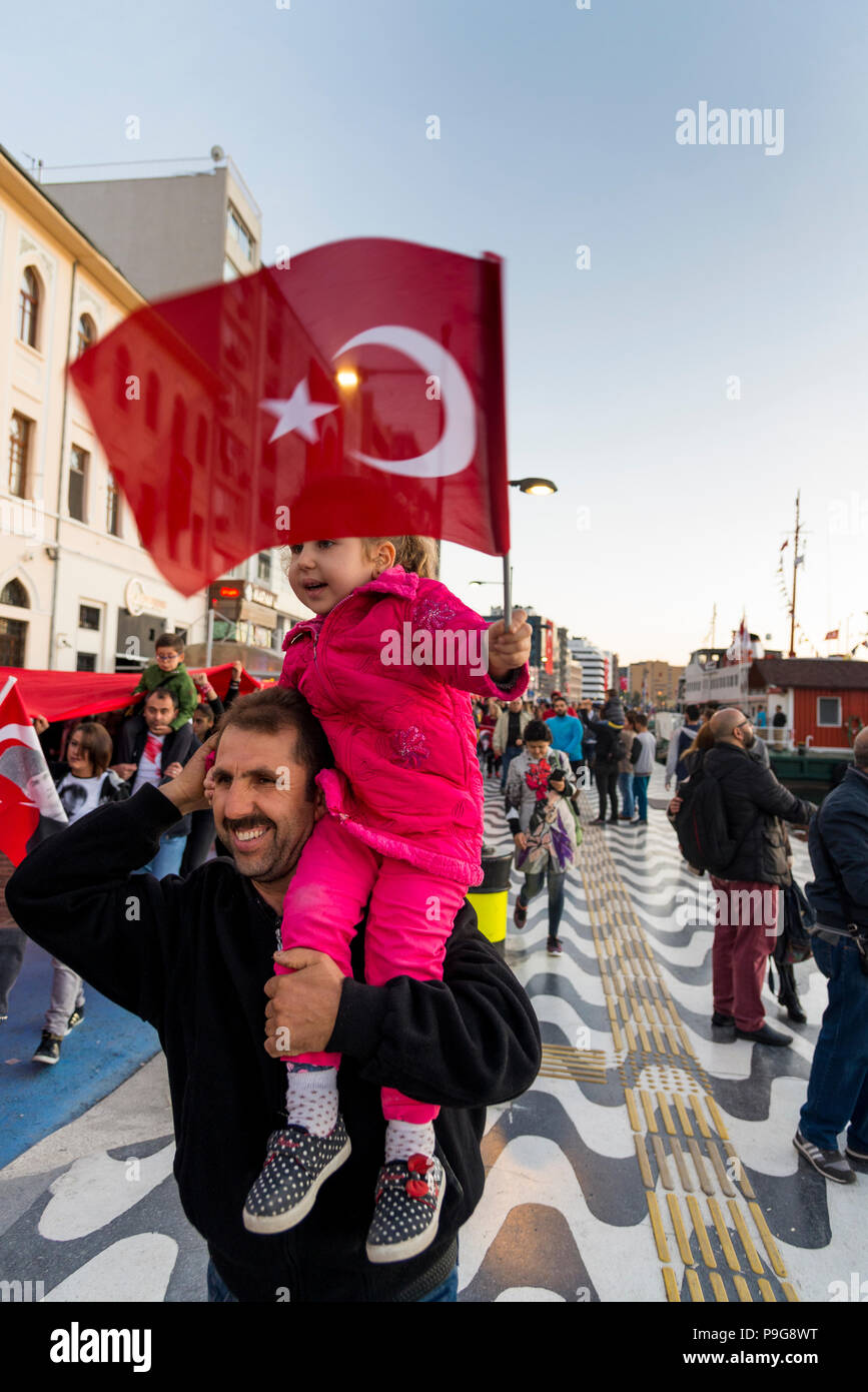 Izmir, Turkey - October 29, 2017: Father and daughter with Turkish flag. Daughter is on shoulders of her father and holding a Turkish flag at Republic Stock Photo
