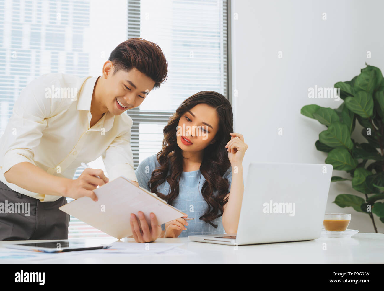 Business people working with computer and doing some paperwork while ...