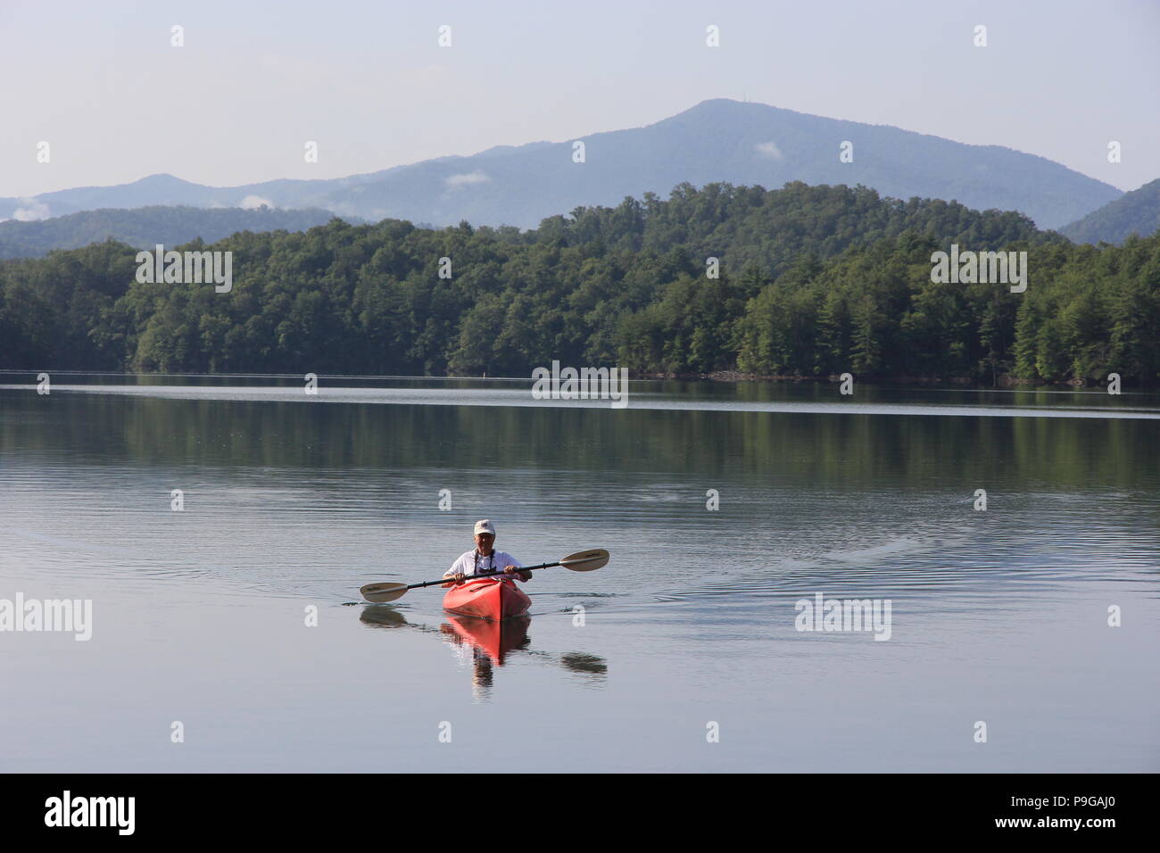 Kayaker on red kayak on Lake Santeetlah in North Carolina, United