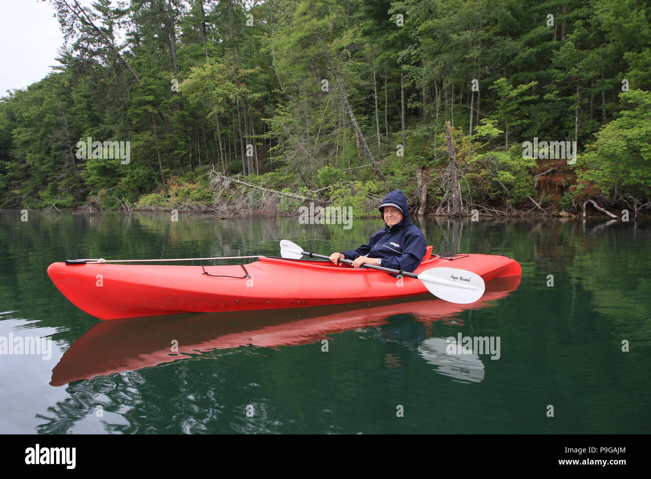 Kayaker on red kayak on Lake Santeetlah in North Carolina, United