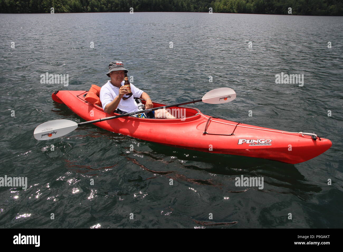 Kayaker on red kayak on Lake Santeetlah in North Carolina, United