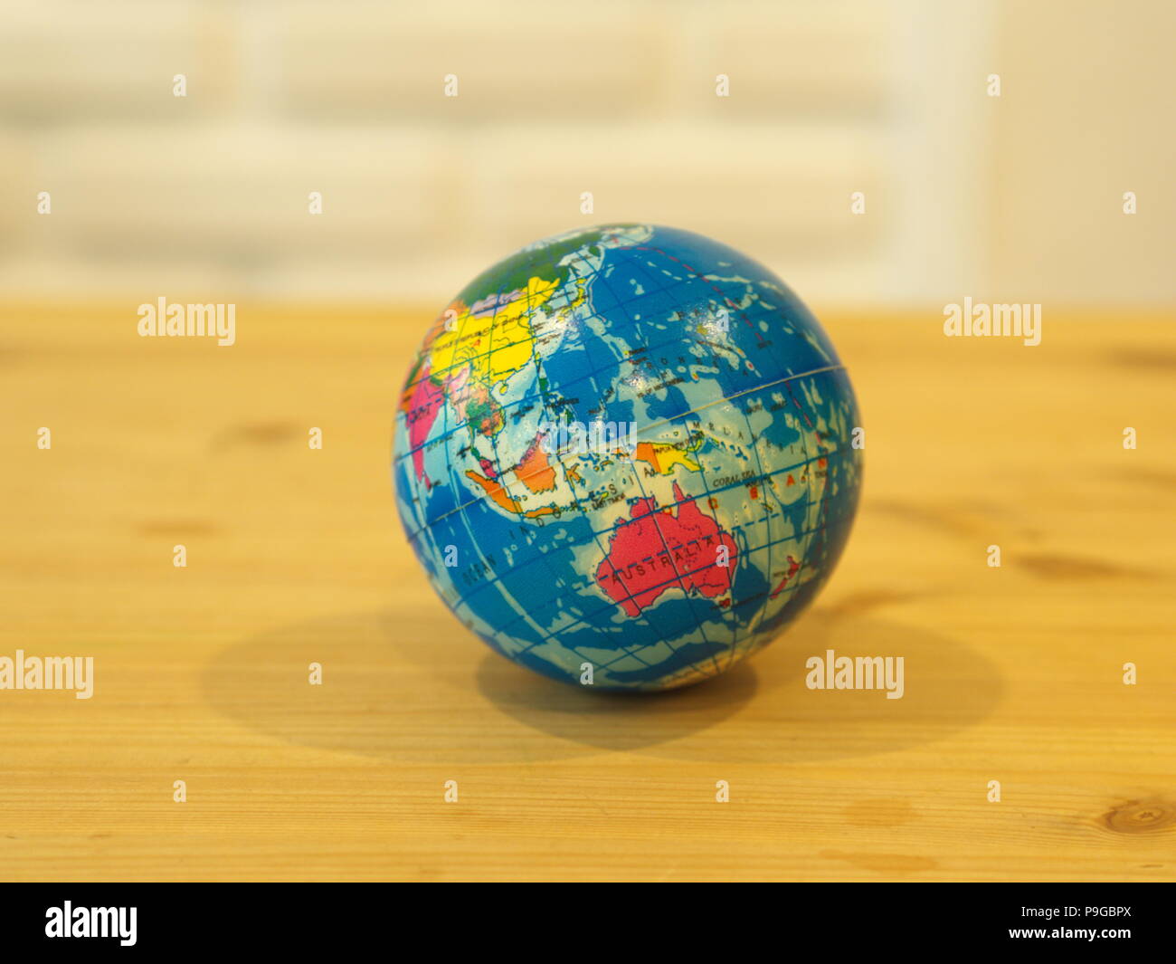 Close Up Mini Globe with Wooden Table Background Stock Photo