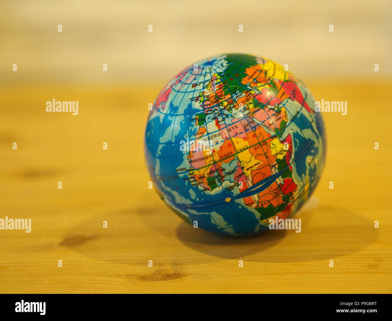 Close Up Mini Globe with Wooden Table Background Stock Photo