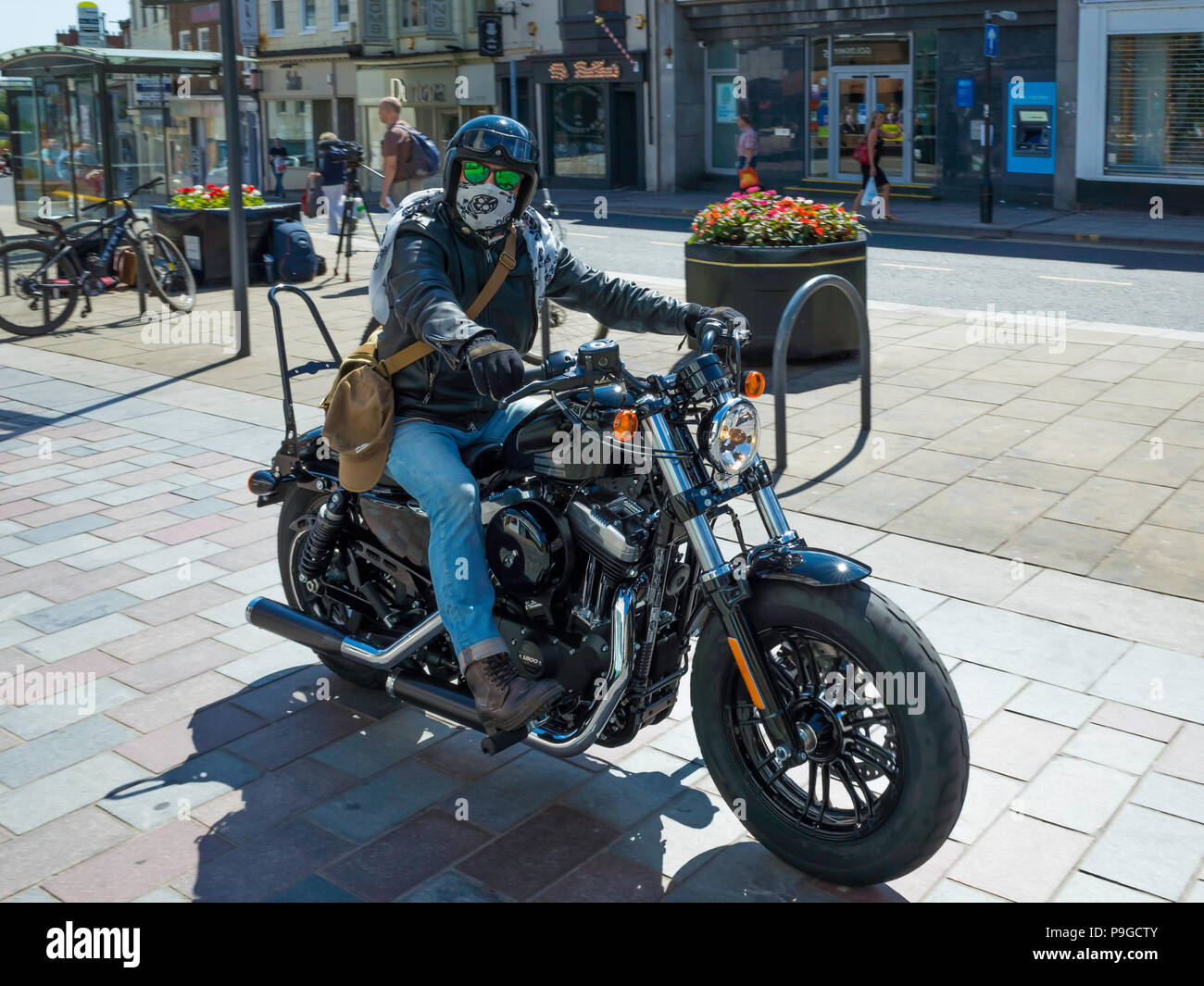 Rider in town centre pulling away on a 1200 cc Harley Davidson FORTY EIGHT motor cycle Stock Photo