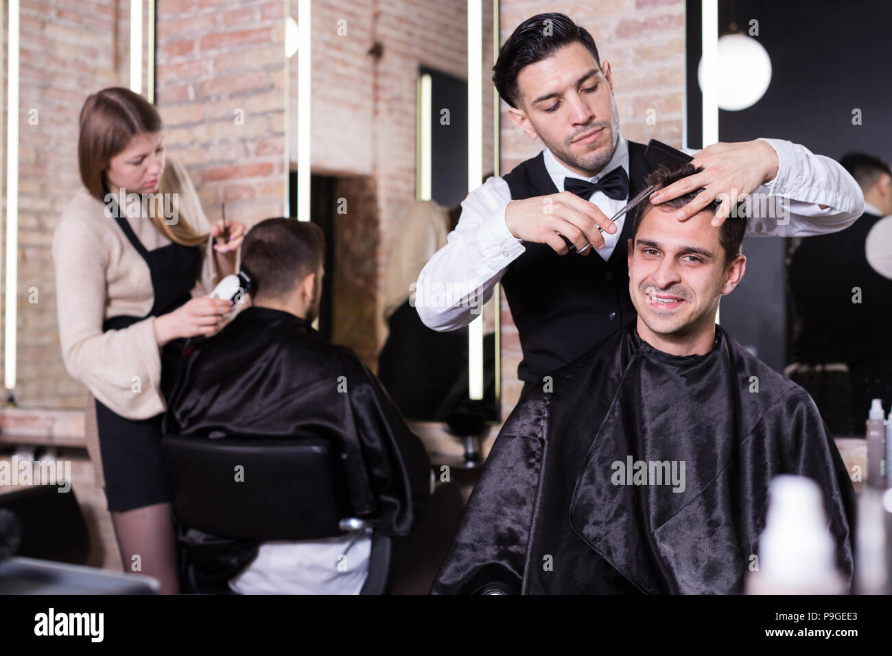 Professional Hairdresser Man Doing Styling Of Handsome Guy At