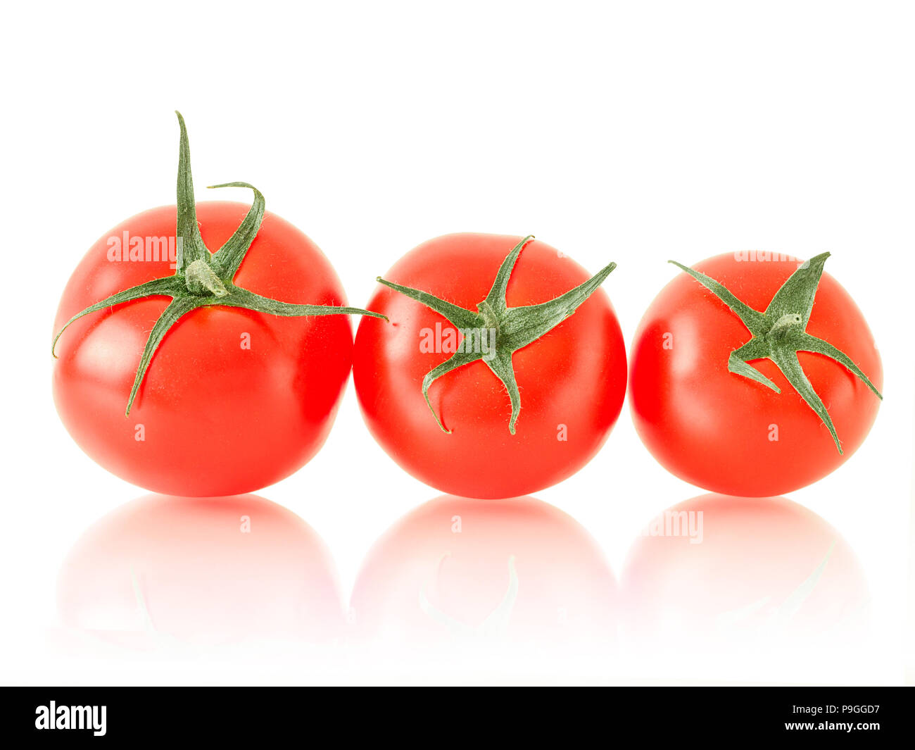 ripe tomato with green leaves Stock Photo