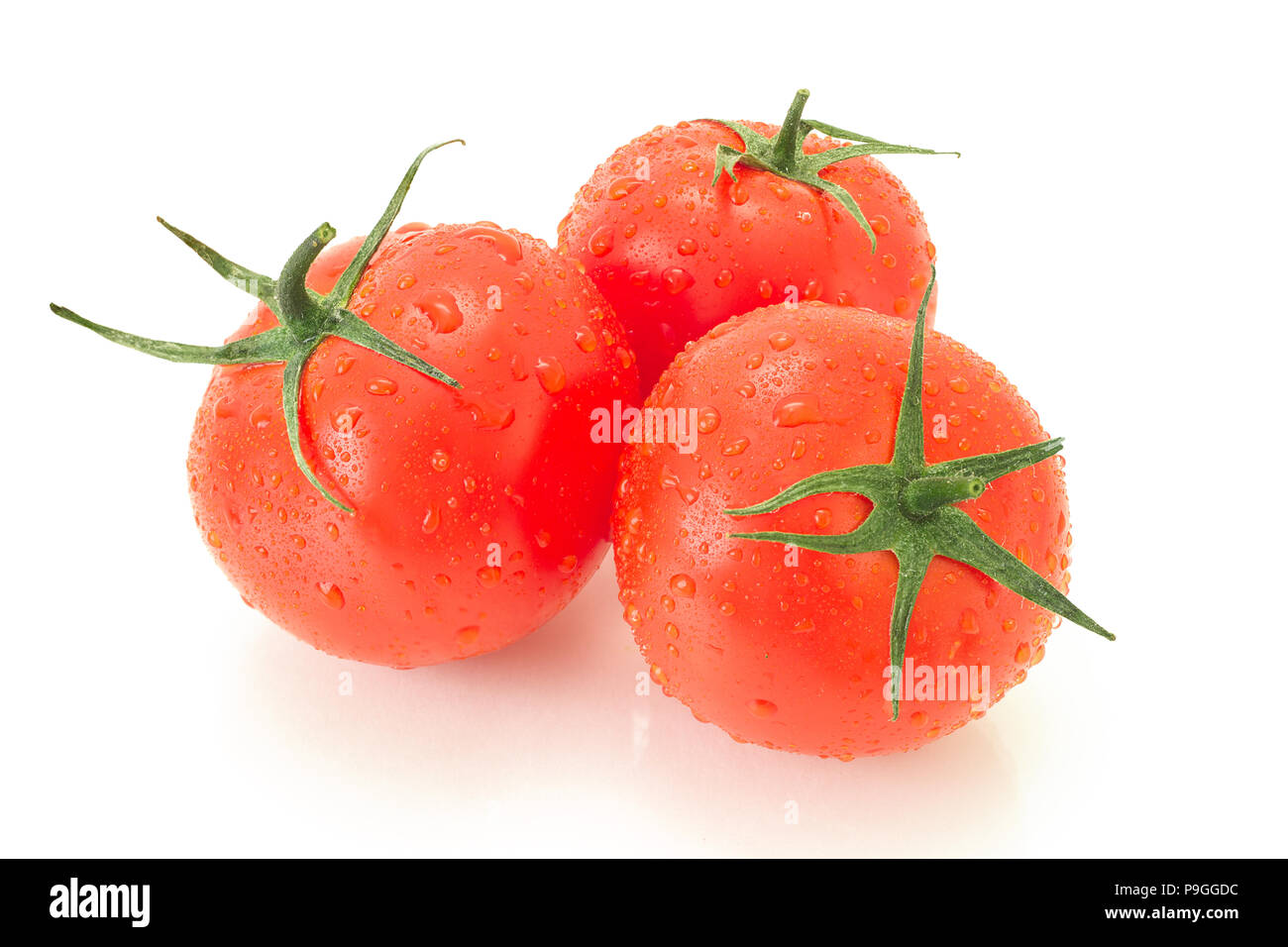 ripe tomato with green leaves Stock Photo