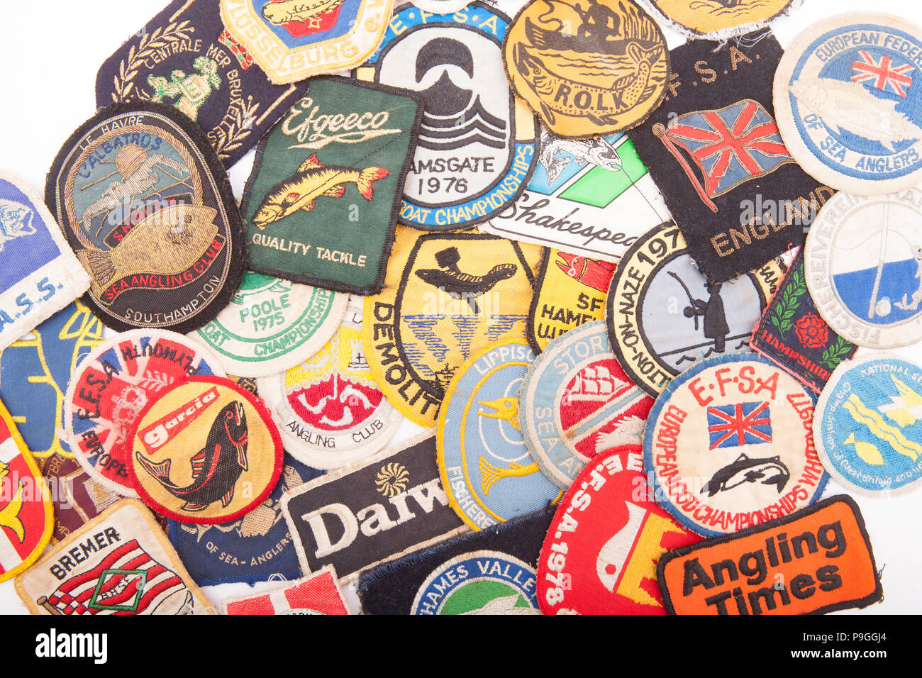 A collection of fishing badges, or patches, designed to be sewn onto clothing. From a vintage fishing tackle collection. Dorset England UK GB Stock Photo