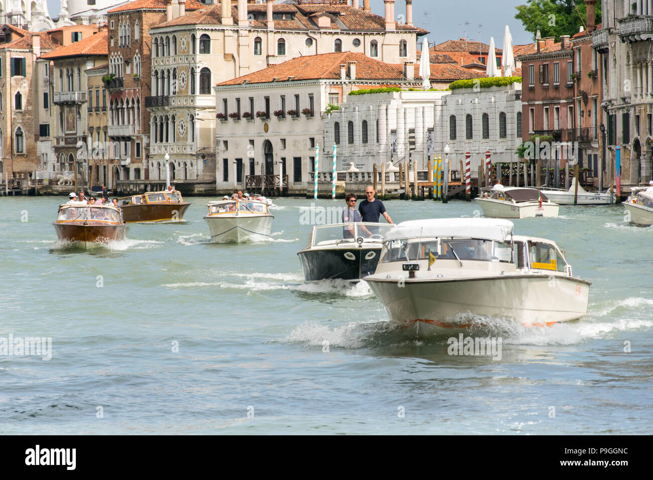 Europe, Italy, Veneto, Venice. Few motorboats swimming on Canale Grande (Grand Canal) in Venice near Ponte dell'Accademia, heading Ponte di Rialto. Stock Photo