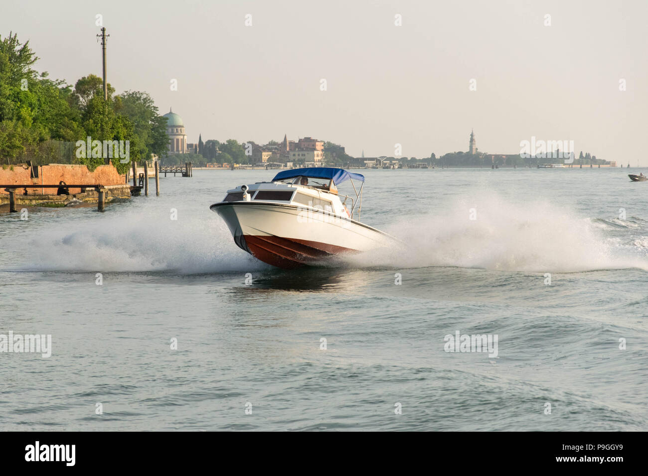 Europe, Italy, Veneto, Venice. Fast motorboat breaking waves. LagUne di ...