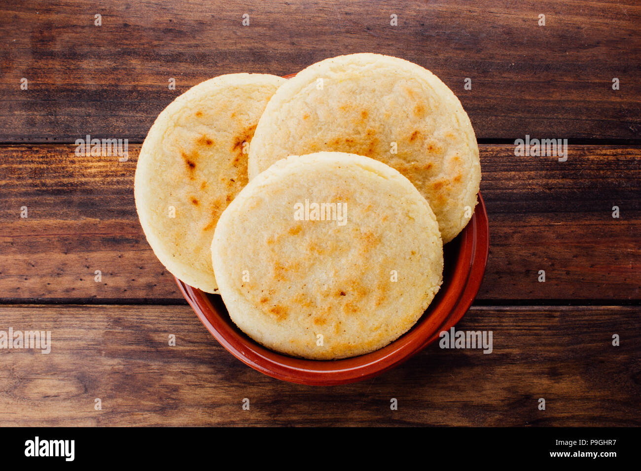 Plate with arepas on a rustic wooden background, a typical food in ...