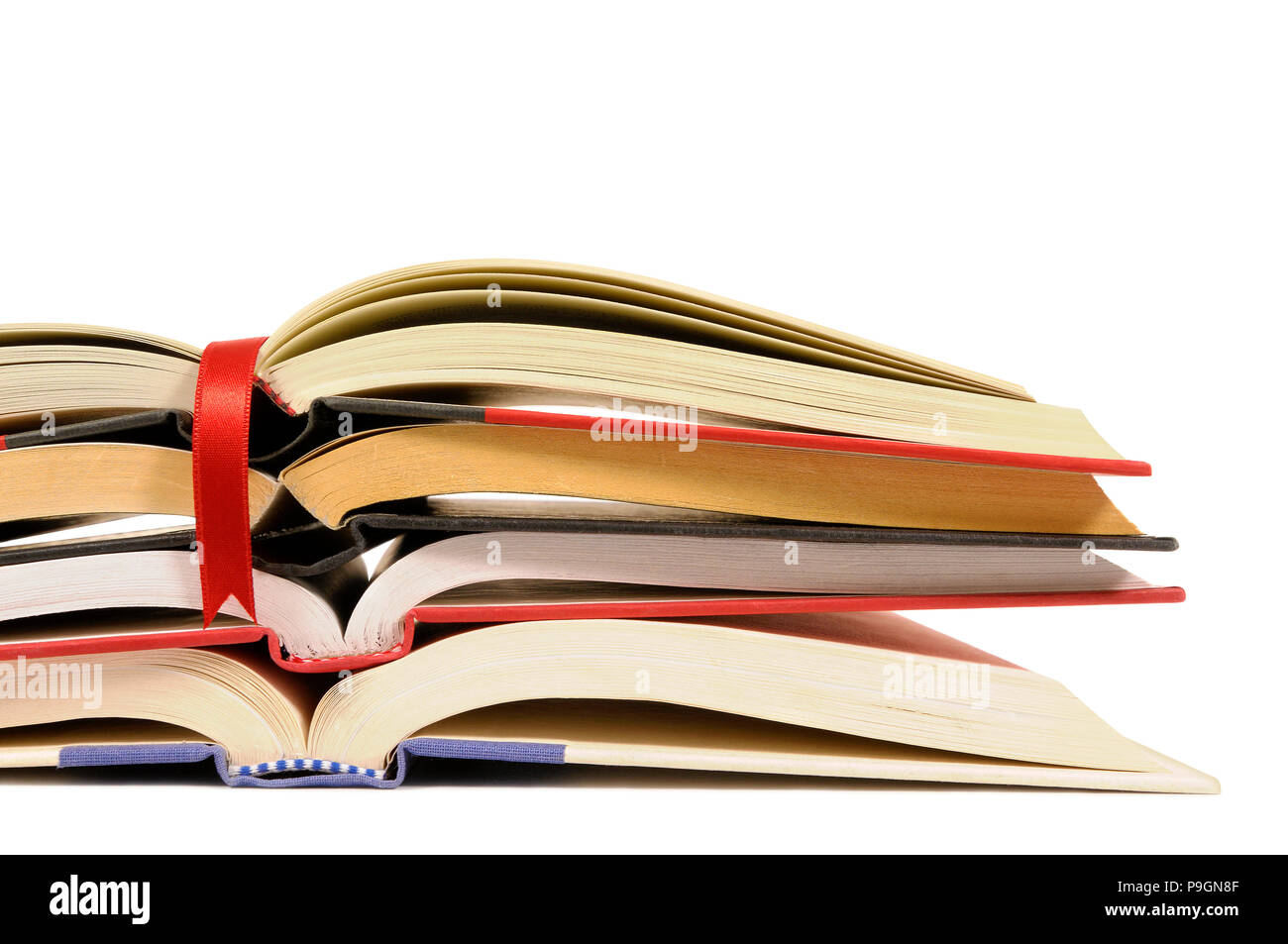 Small pile of open books with red bookmark ribbon isolated on white