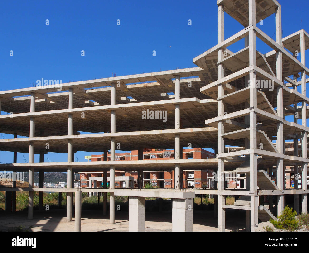 A half built shell of an abandoned hotel construction in Ibiza, Spain Stock Photo