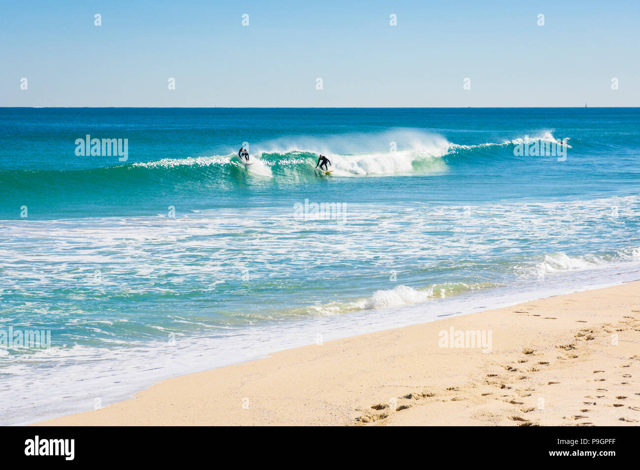 Surfers riding small waves at the beach break, Scarborough Beach, Perth, Western Australia Stock Photo